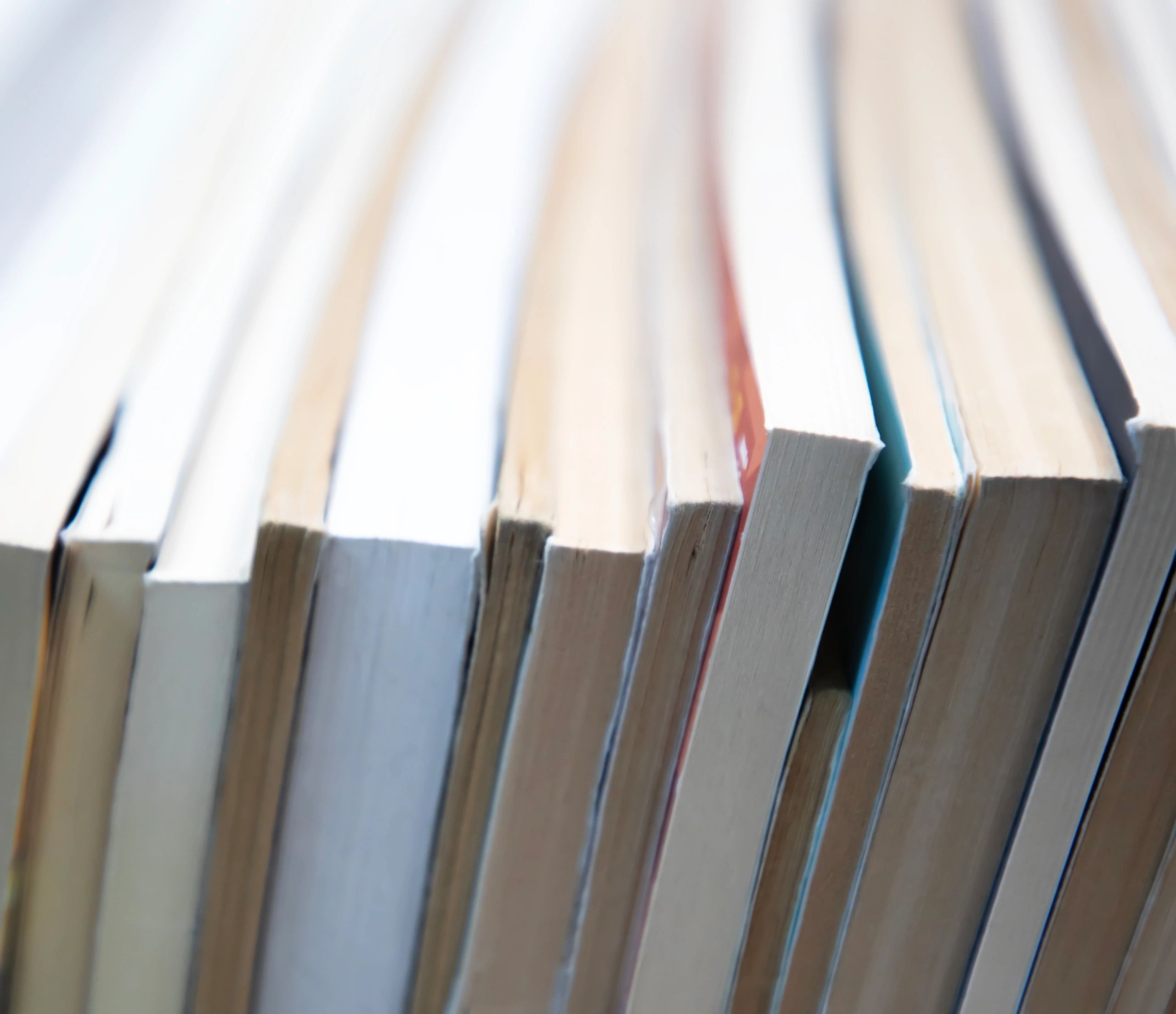 Stacks of books on shelves with warm, bookish atmosphere